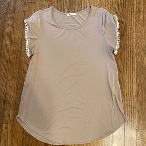 Tan top with crochet detail around sleeve